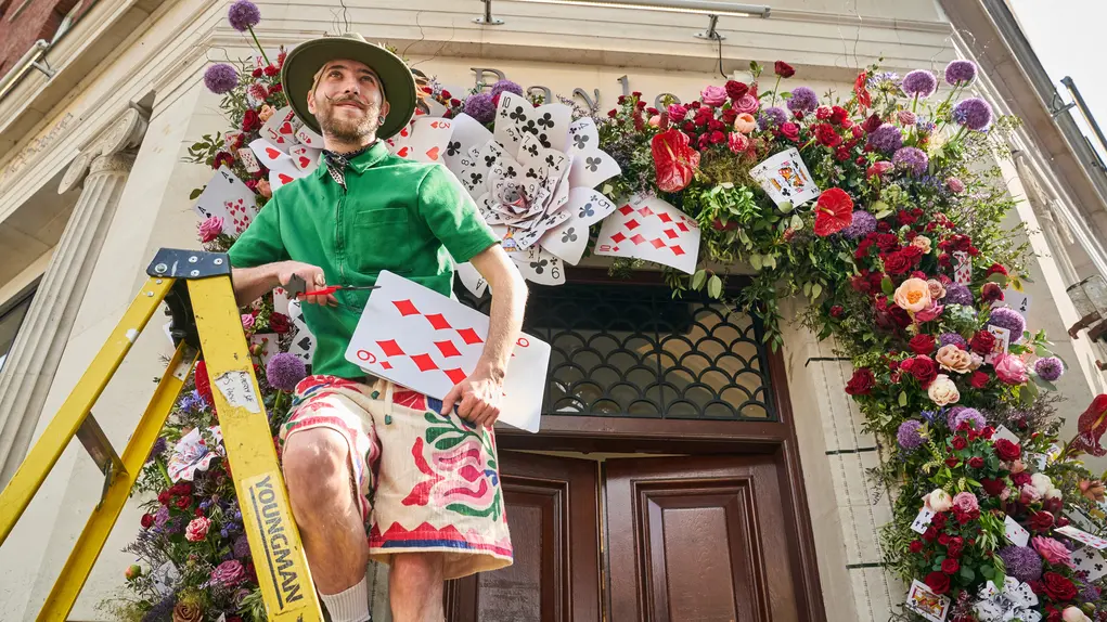 A man puts the finishing touches to the floral display at Bayley and Sage