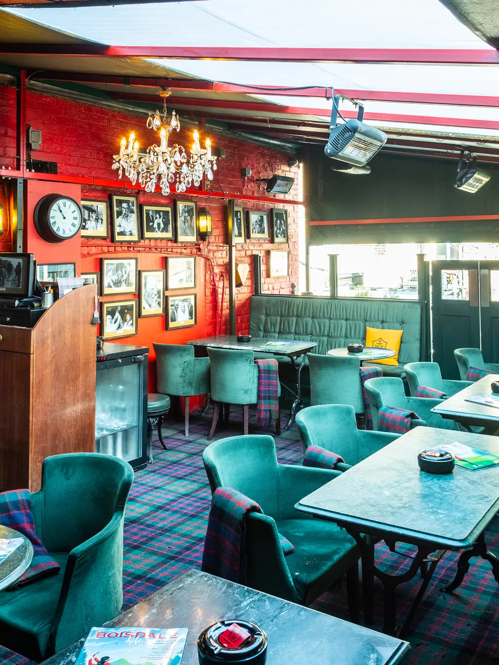 The interior of Boisale with green velvet chairs and red walls